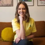 Katlin Knutson of Lemon Fresh Cleaners sitting on an indoor couch