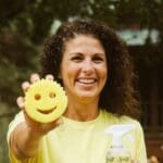 Breann Stiefel, owner of Lemon Fresh Cleaners, smiling and holding a cleaning sponge.