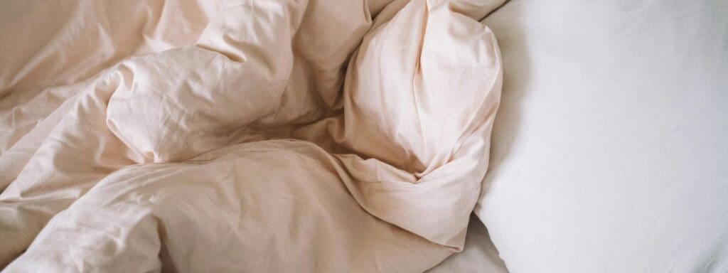Unmade white bed